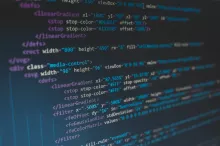 A photo of a computer screen showing HTML code with a variety of color formatting.